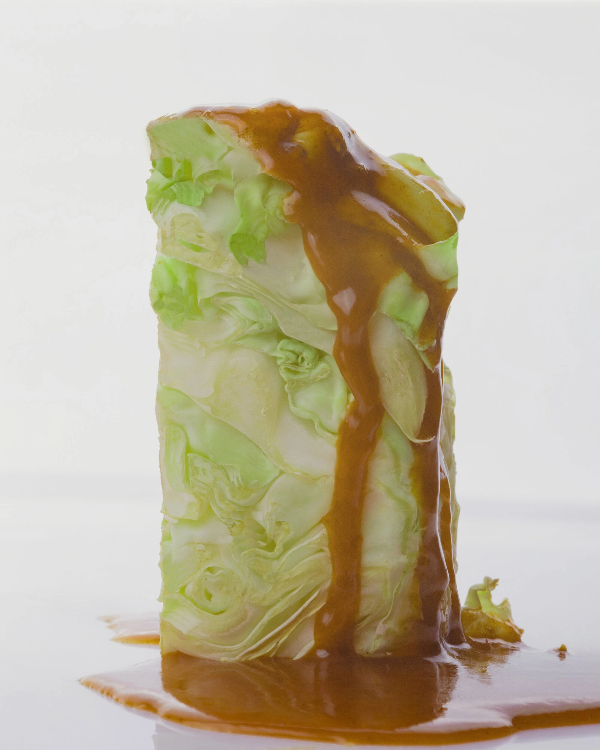 Stack of cabbage leaves with brown sauce running down