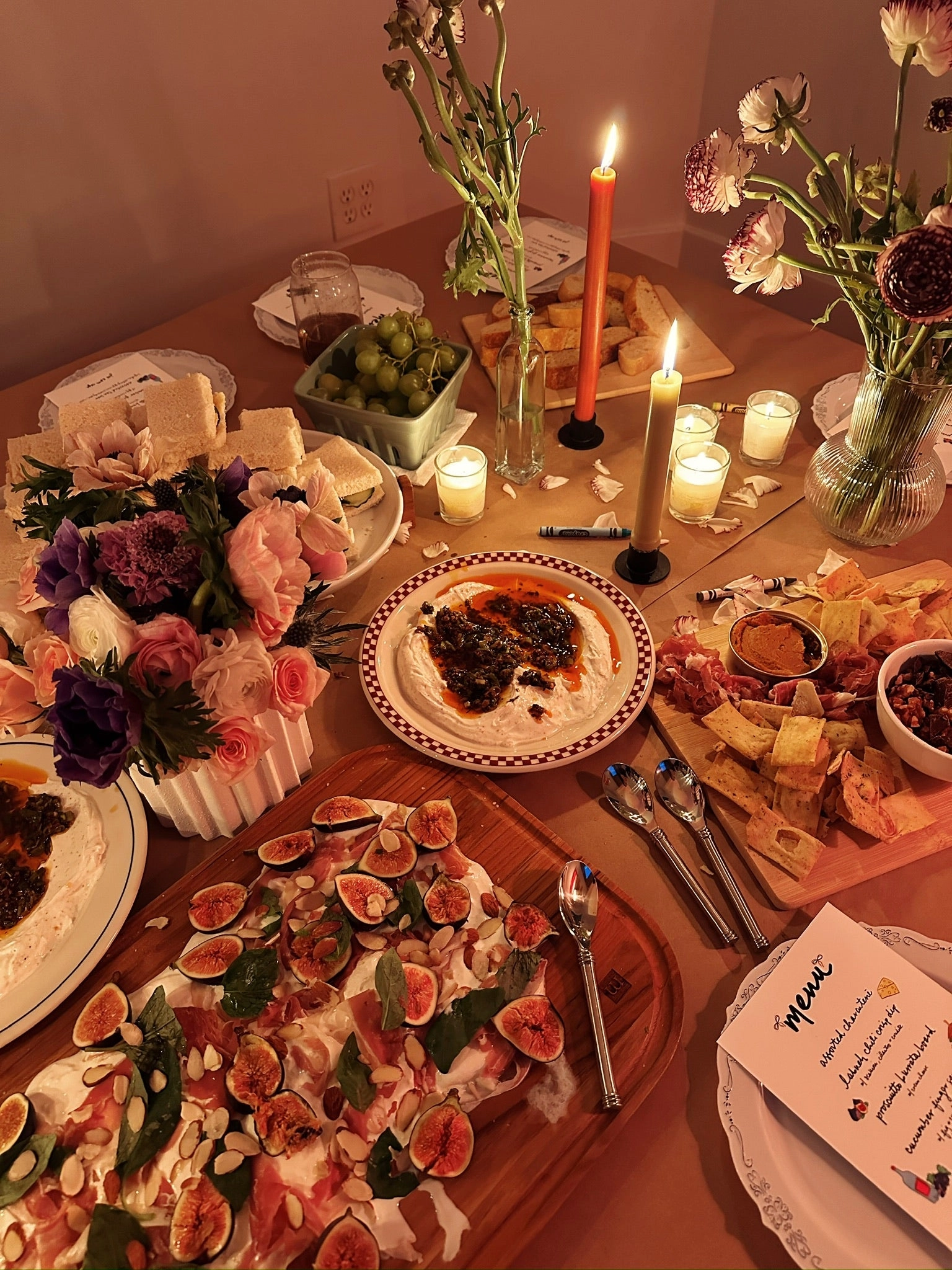 A candlelit table spread with a chili crisp labneh dip