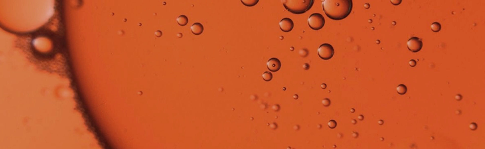 Close-up of orange oil with bubbles